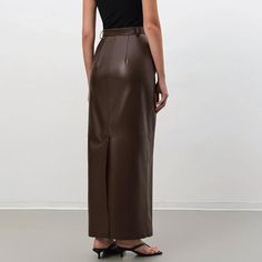 Discover Timeless Elegance and Comfort Embrace the perfect blend of style and comfort with our Vintage Brown Faux Leather Skirt, designed for the modern woman. Crafted with meticulous attention to detail, this ankle-length skirt is a testament to sophistication and versatility, making it an essential addition to your autumn/winter wardrobe. Exceptional Design and Quality Made from a luxurious combination of polyester, spandex, and viscose, this skirt offers a premium leather look without compromising on comfort. The straight silhouette and empire waistline flatter all body types, ensuring a fit that’s both comfortable and stylish. The solid pattern and subtle pocket decoration add a touch of understated elegance, perfect for the office or a night out. Perfect for Any Occasion Whether you'r Elegant Fall Maxi Skirt For Office, Chic Brown Maxi Skirt For Fall, Chic Faux Leather Midi Skirt, Brown Fitted Maxi Skirt For Party, Chic Long Pencil Skirt For Fall, Elegant Faux Leather Pencil Skirt For Fall, Modern Asymmetrical Skirt For Fall, Elegant Brown Asymmetrical Skirt, Elegant Brown Maxi Skirt For Party