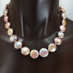 These coin pearls are special! They are solid nacre since they were tissue nucleated. They have not been bleached, so they are a soft pink/cream color and are particularly lustrous. You could wear these for the wedding and then keep wearing them! Looks great with jeans or in the office, or for the opera, and simple enough for everyday wear since it is really a neutral color. They are knotted on silk and finished with my signature beads and a handsome clasp in sterling silver. They will come pack Pink Round Pearl Necklace Gift, Pink High Luster Round Pearl Necklace, Pink High Luster Pearl Necklace, Handmade Mother Of Pearl Round Necklace, Formal Pink Baroque Pearl Jewelry, Handmade Mother Of Pearl Necklace, Pink Pearl Necklace With High Luster, Luxury Pink Pearl Necklace For Wedding, Pink Round Pearl Necklace