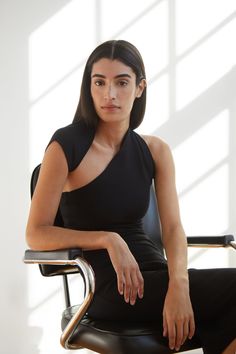 Sleeveless in the City...meet our Manhattan Sleeveless Midi. She's THE dress for both fancy invites or when you just want to look everyday sleek and unique. Fashioned from our soft, mid-stretch European ponte fabric, she features an unforgettable silhouette thanks to her one-shoulder wrap-around neckline and cap sleeve. We hope you're ready for the compliments. | Marcella Manhattan Sleeveless Midi Dress in Black | Women's Size Large | Ponte | Fall And Winter Clothing Modern Sleeveless Mini Dress For Night Out, Modern Sleeveless Dress For Night Out, Modern Fitted Sleeveless Mini Dress, Elegant Black One-shoulder Sleeveless Dress, Elegant One Shoulder Black Sleeveless Dress, Chic Sleeveless Dress With Asymmetrical Neckline For Evening, Chic Sleeveless Dress With Asymmetrical Neckline For Party, Modern Sleeveless Stretch Dress, Modern Stretch Sleeveless Dress