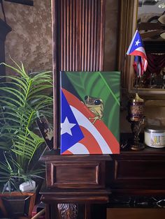 a painting of a frog on a green and red flag next to a potted plant