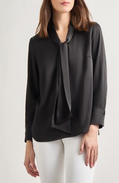 This tie-neck blouse made from  lightweight crêpe de chine is a perfect workday option. Ties at neck Long sleeves 100% polyester Hand wash, line dry Imported Chic Silk Tops For Work, Chic Tie Neck Tops For Workwear, Silk Crepe Tops For Spring Workwear, Black Tie Neck Blouse For Work, Chic Silk Crepe Blouse For Office, Spring Silk Crepe Blouse For Work, Elegant Silk Crepe Blouse For Work, Chic Viscose Tie Neck Top, Viscose Tie Neck Top For Work