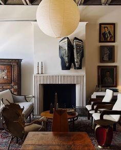 a living room filled with furniture and a fire place in front of a painting on the wall