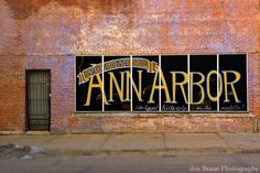 an advertisement on the side of a building that says,'ann arbor'in large letters