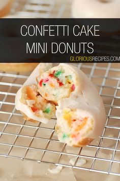 a close up of a muffin on a cooling rack with the words confetti cake mini donuts