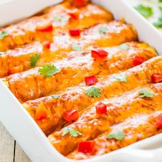 sweet potato, corn and black bean enchiladas in a white casserole dish