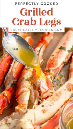 cooked crab legs being drizzled with sauce