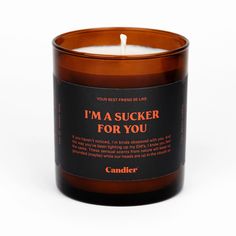 a candle that says i'm a sucker for you on the front and side