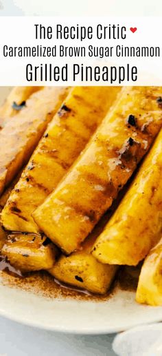 grilled pineapples on a white plate with text overlay reading the recipe gritic caramelized brown sugar cinnamon grilled pineapple