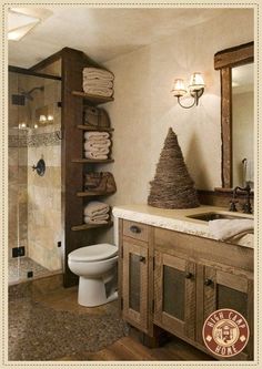 a bathroom with a sink, toilet and shelves filled with towels on top of it