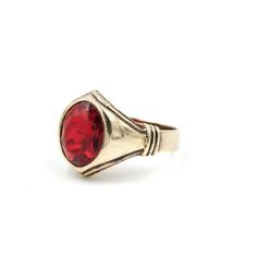 "Classic 10Kt yellow gold signet ring with a red ruby glass center. Incredible Art Deco style lines and detailing set this ring apart from similar statements. This ring has stood the test of time but does show signs of wear as the glass facets are heavily worn with a few flea bites (best seen in photo #8). Light scratching to the gold but nothing major. A jeweler could replace the glass with a stone if you want a different look.  Marked \"10K\" and tested to guaranteed 10 karat gold. Size: 8.75  Measures: .63\" tall (in front)  Weight: 5.52 grams Please feel free to contact me with questions and/or for additional photos. More gold pieces in the shop: 14Kt Gold Band - https://etsy.me/3vu8JiQ 14Kt & Seed Pearl Brooch - https://etsy.me/391Uw59 *Free Domestic Shipping on Orders Over $35* All i Vintage Ruby Rings With Polished Finish, Modern Red Ring For Formal Occasions, Modern Red Rings For Formal Occasions, Antique Ruby Rings With Polished Finish, Formal Ruby Signet Ring With Bezel Setting, Ruby Signet Ring With Bezel Setting For Formal Occasions, Formal Red Rings With Bezel Setting, Formal Red Engraved Ring With Polished Finish, Modern Red Ruby Jewelry