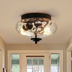 the light fixture in this kitchen is made out of glass and has three lights on each side