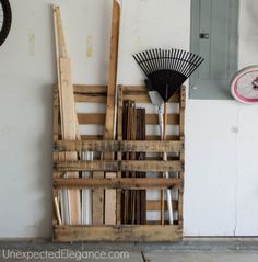 a pile of wooden pallets next to a wall with a clock on the wall