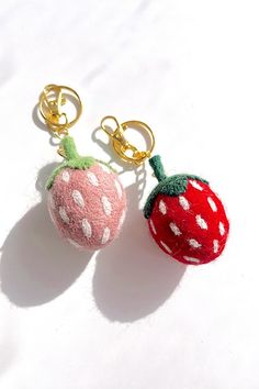 two keychains with one strawberry and one strawberry on it, both made out of felt