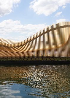 a large wooden structure sitting on top of a body of water