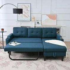 a living room with a blue couch and coffee table on the floor next to it