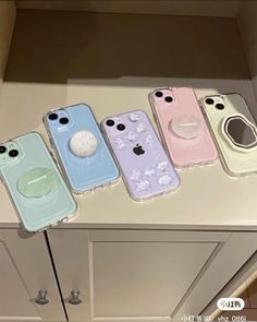 four iphone cases sitting on top of a counter