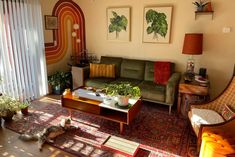 a living room filled with furniture and plants