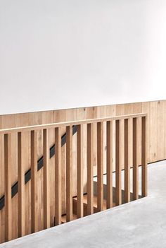 an empty room with wooden slats on the wall