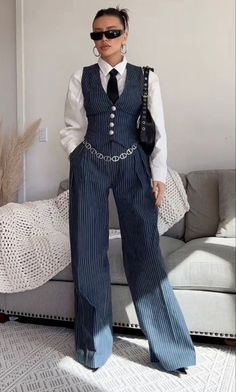 The 2-piece suit consists of a pair of high-waisted, wide-legged trousers and a matching vest. Both pieces are made from a pinstriped fabric, giving them a classic and elegant appearance. US women's size Fits true to size Suit Vest Outfits, Mode Harajuku, Princesa Sophia, Fashion 90s, 90's Fashion, Woman Suit Fashion, Sweater Dress Women, Vest Outfits, Professional Outfits