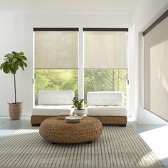 a living room with two couches and a coffee table in front of large windows