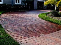 a brick driveway in front of a house