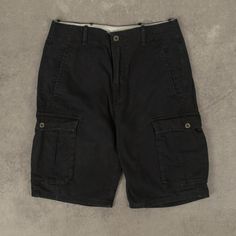 Men's Vintage Levi's Cargo Shorts  + Closure: Zip  + Colour: Black  + Size Label States: Missing  + Actual measurements (inches): W30  + Measurements (Inches): Hem = 10, Rise = 10  Please note that all vintage items have been previously worn, and may show some signs of previous wear. However, any significant damage will be photographed and/or stated in the items listing. Please note that damage to the inside may not always be photographed or listed. Black Casual Cargo Pants With Built-in Shorts, Black Cargo Pants With Belt Loops, Black Cargo Shorts With Belt Loops, Black Short Length Cargo Pants With Belt Loops, Black Short-length Cargo Pants With Belt Loops, Black Cargo Shorts With Patch Pockets, Black Bottoms With Patch Pockets, Black Bottoms With Patch Pockets Short Length, Black Bottoms With Patch Pockets And Short Length