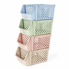 four plastic baskets stacked on top of each other in different colors and sizes, with holes at the bottom