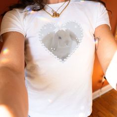 Fluffy bunny, so soft and delicate ʚɞ ♡ More of Coquette Aesthetic: https://www.etsy.com/shop/RainieshopDesign?ref=seller-platform-mcnav&section_id=1   PRODUCT DETAILS   ♡ Gildan Heavy Cotton™ Tee ♡ Made with 100% cotton ♡ Midweight fabric (5.3 oz/yd² (180 g/m ♡ Loose fit ♡ Sewn-in label ♡ Runs true to size  SIZING   ▸ Please refer to the last picture with size chart for sizes and product dimensions.  ▸ Be aware that these shirts are baby tees that can have a snug fit if you choose your normal size your smaller. If you prefer a more relaxed style or find a tight fit uncomfortable, you may want to consider selecting a size 1-2 sizes larger than your usual size. ▸ To find your best fit, take your favorite baby tee that you owned, lay it out flat and measure from armpit to armpit. Then, use t Cute White T-shirt With Bunny Design, Fitted White Kawaii T-shirt, White Fitted Kawaii T-shirt, Cute Bunny Design Crew Neck T-shirt, Cute Bunny Design Short Sleeve T-shirt, Cute Short Sleeve T-shirt With Bunny Design, Cute Bunny Design T-shirt, Cute Crew Neck Top With Bunny Design, Cute White Bunny Design T-shirt