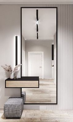 an empty hallway with a mirror and stool