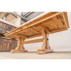 a wooden table sitting on top of a carpeted floor