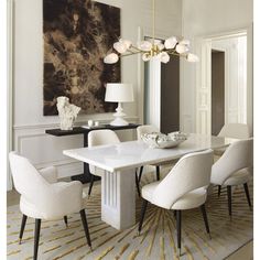 an elegant dining room with white chairs and a large painting on the wall above it