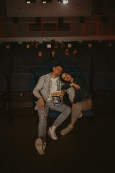 a couple in love went to watch a movie in the cinema in the evening.  they eat popcorn and watch a movie.  photo idea Movie Theatre Couple Pics, Movie Theater Couple Pictures, Couple Cinema Date Aesthetic, Movie Theater Engagement Photos, Couple Watching Movie, Movie Night Outfit, Story References