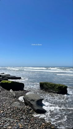 some rocks and water on the beach with a quote above it that reads i love to be here