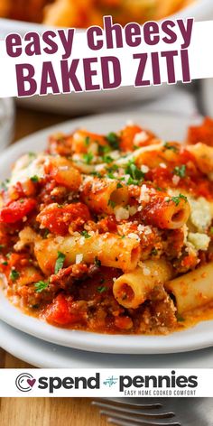 a white plate topped with pasta covered in marinara sauce and parmesan cheese