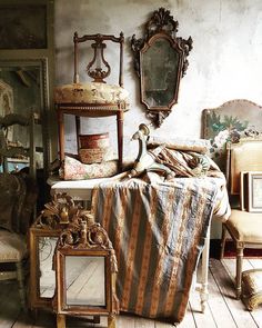 an old fashioned bedroom with antique furniture and mirrors