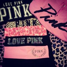 pink, black and leopard print shirts are laying on top of a leopard print blanket