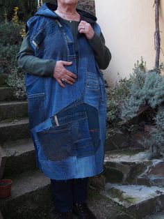 an older woman standing in front of some steps