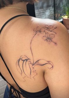 a woman with a flower tattoo on her back