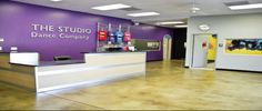 the dance company is located in an office building with purple walls and white counter tops