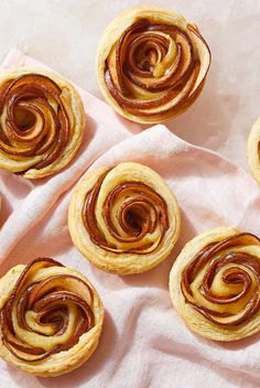 several cinnamon rolls on top of a pink napkin