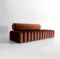 an orange couch sitting on top of a white floor