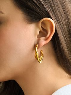 This Gold wavy hoops earrings   may feature intricate detailing such as textured surfaces , further enhancing their beauty and versatility. Elevate any look with their glamour and timeless charm. Textured Metal Hoop Earrings For Gift, Hammered Gold Plated Earrings, Formal Gold-plated Hoop Earrings, Elegant Textured Brass Jewelry, Textured Gold-plated Jewelry, Gold Tarnish-resistant Hoop Earrings, Elegant Textured Gold Plated Earrings, Wavy Hoop Earrings, Luxury Gold-plated Tarnish-resistant Hoop Earrings