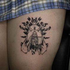 a woman's thigh with a tattoo design on it