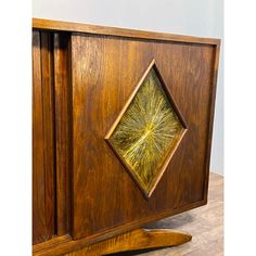 a wooden cabinet with an intricate design on the front and side panels, inlaid with gold thread