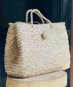 "Presenting our exquisite Straw Basket Bag, meticulously handwoven in Marrakech, Morocco, using premium palm leaves. Embodying the essence of \"Slow Fashion,\" this eco-friendly and ethically crafted accessory epitomizes the charm of sustainability and green living, ideal for the straw trend dominating this Spring & Summer season. Versatile and timeless, this braided bag complements any occasion, making it a quintessential summer staple. Whether for a day at the beach, a leisurely stroll, or even as a chic home storage solution, its functionality knows no bounds. A must-have accessory that seamlessly transitions from stylish holiday companion to practical everyday carryall, ensuring you're always fashionably equipped wherever you go. Its multifunctionality extends to home storage, making i Artisan Straw Bag With Braided Handles For Travel, Palm Leaf Basket Bag For Shopping, Handwoven Top Handle Straw Bag For Travel, Handwoven Natural Straw Bag With Top Handle, Handwoven Natural Straw Top Handle Bag, Handmade Top Handle Straw Bag For Travel, Natural Handwoven Top Handle Straw Bag, Travel Basket Straw Bag With Rolled Handles, Vacation Basket Straw Bag With Rolled Handles