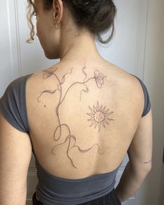 a woman with a tattoo on her back