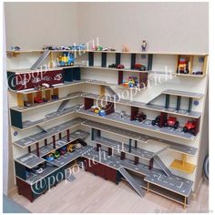 a room with several shelves filled with toy cars and trucks