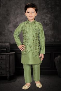 Enhance your little one's appearance on special occasions with this exquisite three-piece kurta pyjama set. The cotton kurta, adorned in a mehendi green hue, features plain patterns that add an elegant touch. The matching overcoat, embellished with scattered embroidered checks, imparts a festive aura. The asymmetrical overcoat, featuring a front button closure, complements the ensemble, while the matching bottoms complete the look with finesse.  Note: Colors may slightly vary due to photographic Festive Green Sherwani With Straight Kurta, Fitted Green Nehru Jacket For Eid, Green Straight Kurta Bandhgala With Dabka Details, Green Straight Kurta Bandhgala With Dabka, Green Bandhgala With Traditional Drape For Eid, Green Traditional Bandhgala For Eid, Green Traditional Drape Bandhgala For Eid, Green Bandhgala With Traditional Drape For Festive Occasions, Designer Green Nehru Jacket For Diwali