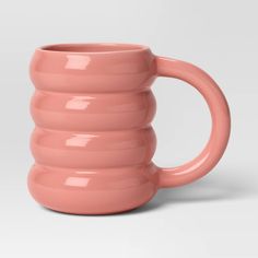 a pink coffee mug is shown on a white background