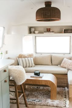 a living room filled with furniture next to a window